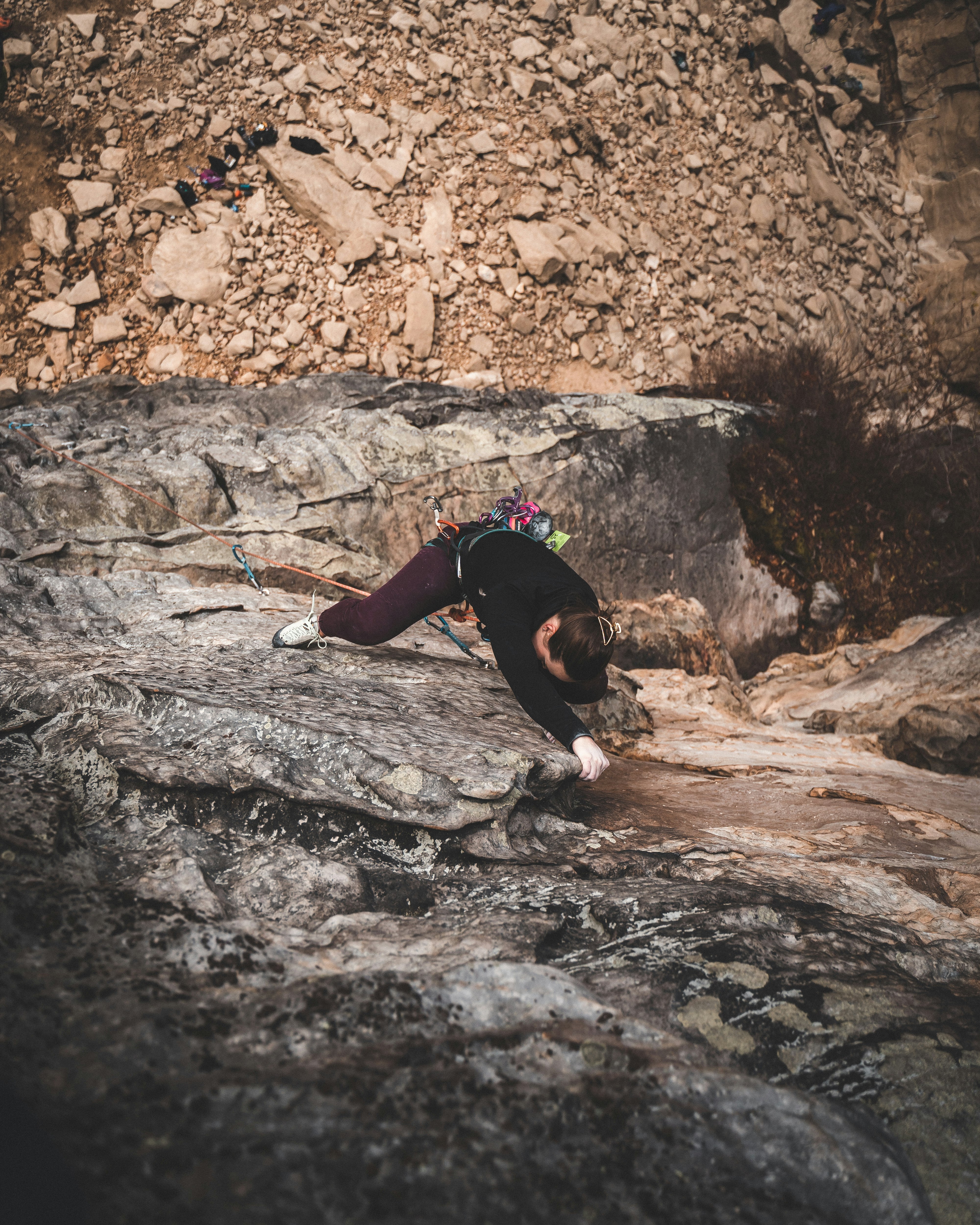 woman doing wall climbing at the cliff